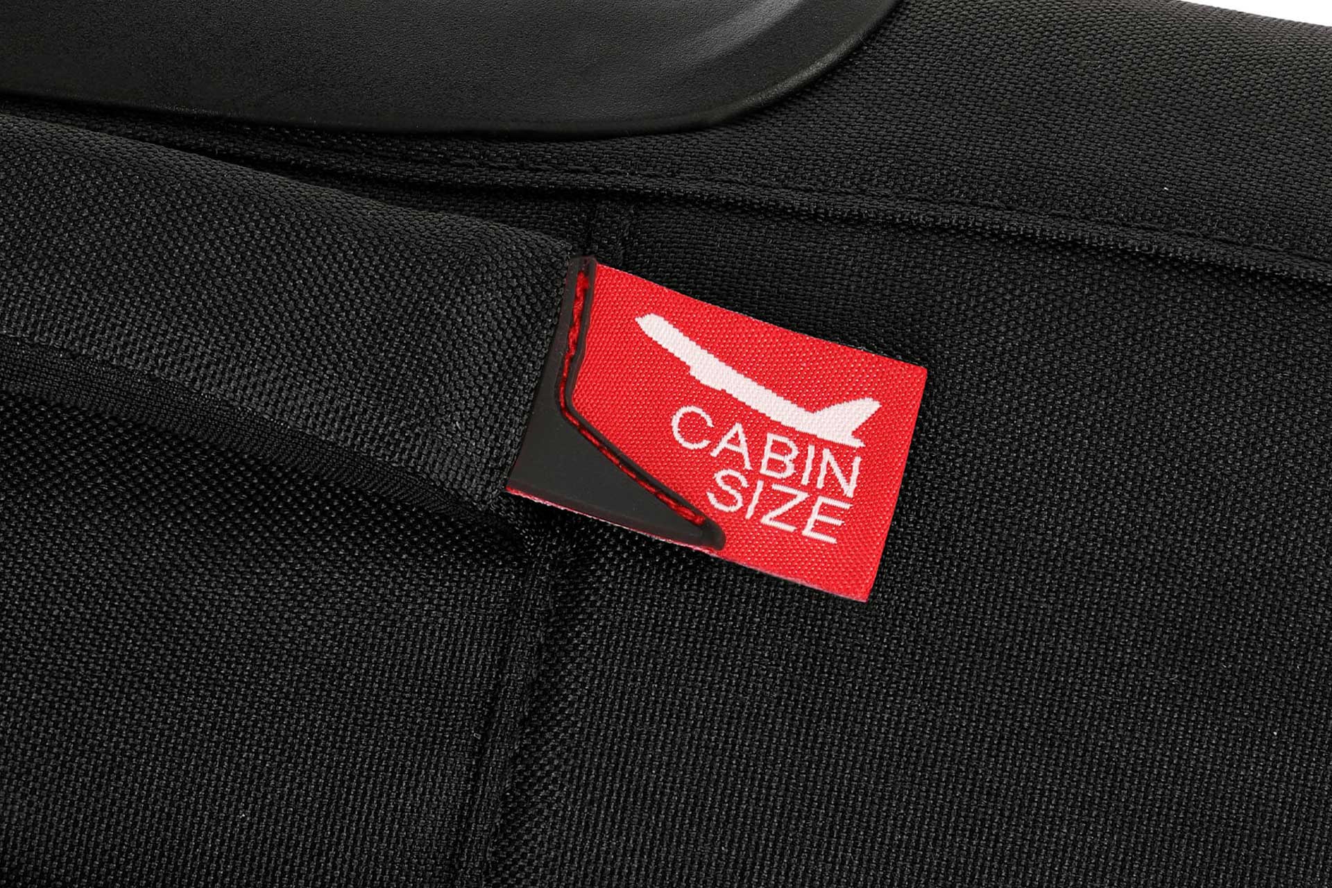 Koffer mit 'Cabin Size' Etikett für Flugreisen Nahaufnahme eines roten 'Cabin Size' Etiketts auf einem schwarzen Koffer