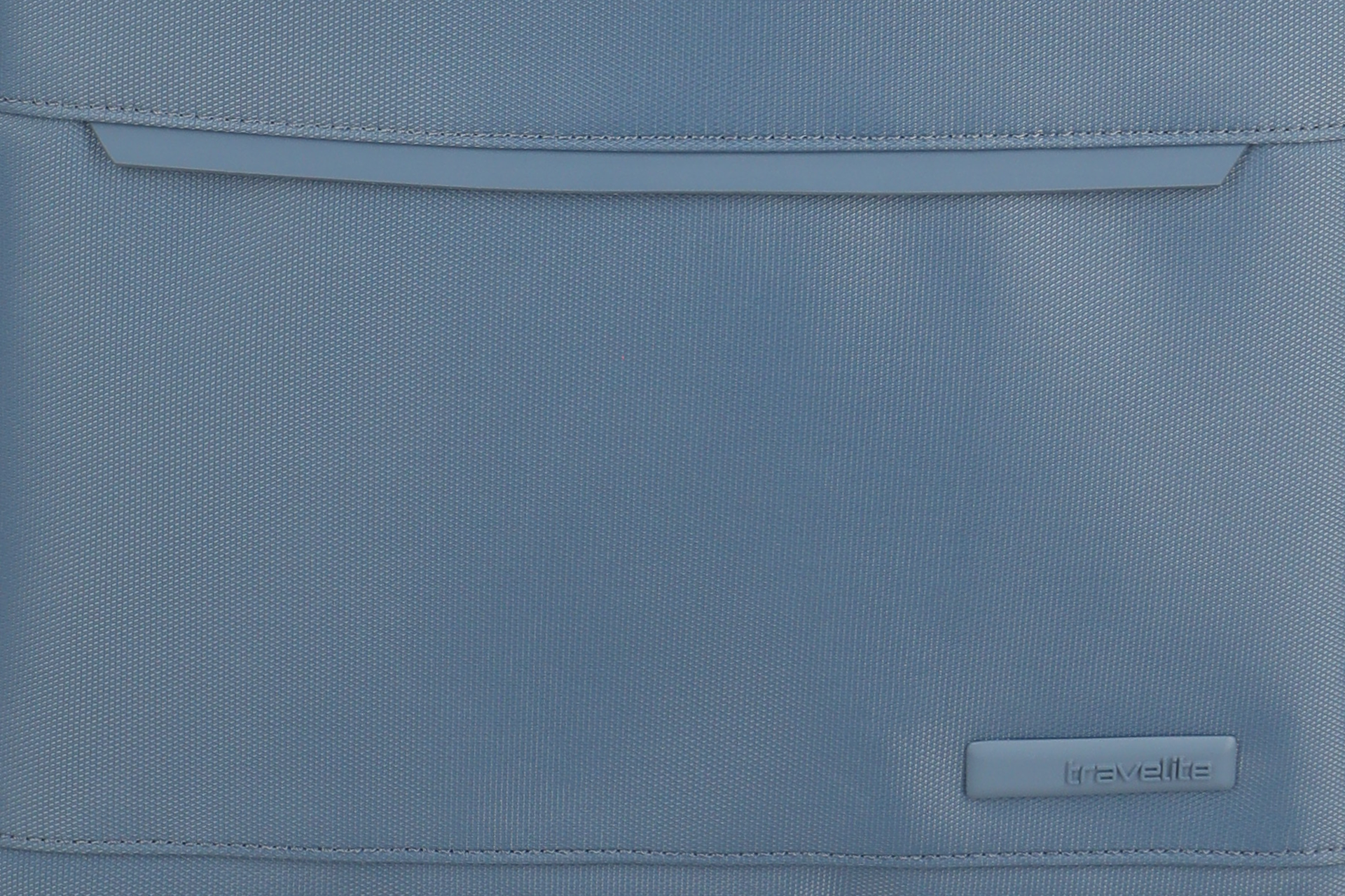 Detailansicht einer blauen Travelite Gepäcktasche aus strapazierfähigem Stoff Nahaufnahme einer blauen Travelite Tasche mit strukturiertem Stoff und sichtbarem Logo