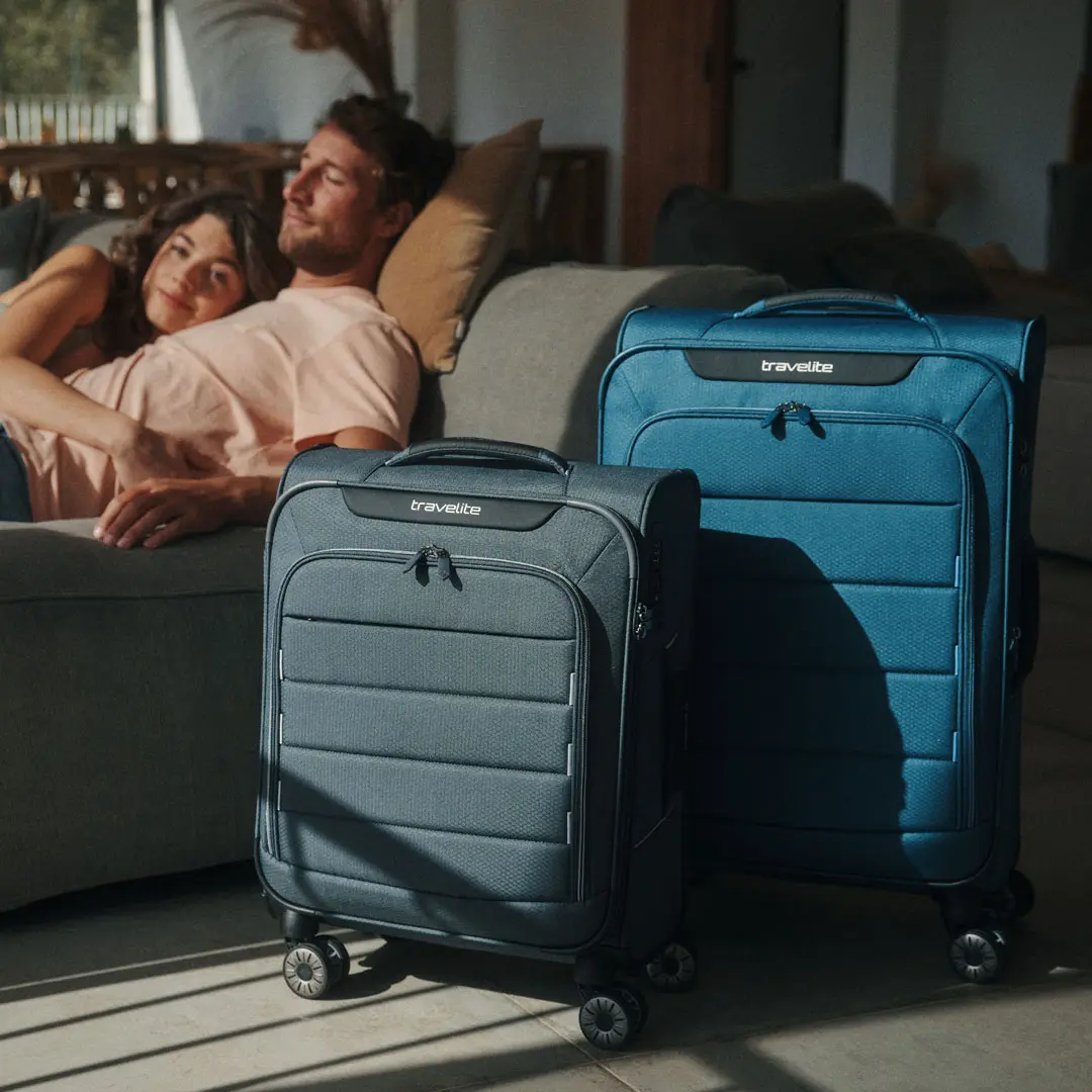 Travelite Weichgepäckkoffer – stylisch und flexibel auf Reisen Zwei Travelite Weichgepäckkoffer vor einem Paar auf der Couch im Wohnzimmer