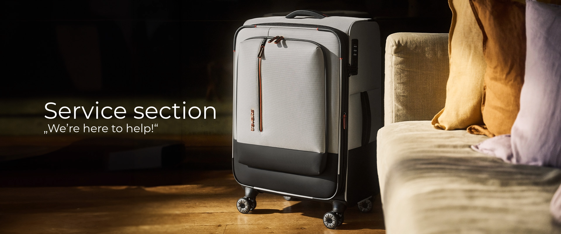 A grey trolley case stands next to a beige sofa with yellow and purple cushions. The suitcase has a handle, castors and a combination lock. "Service section - We're here to help!" is written in the foreground.