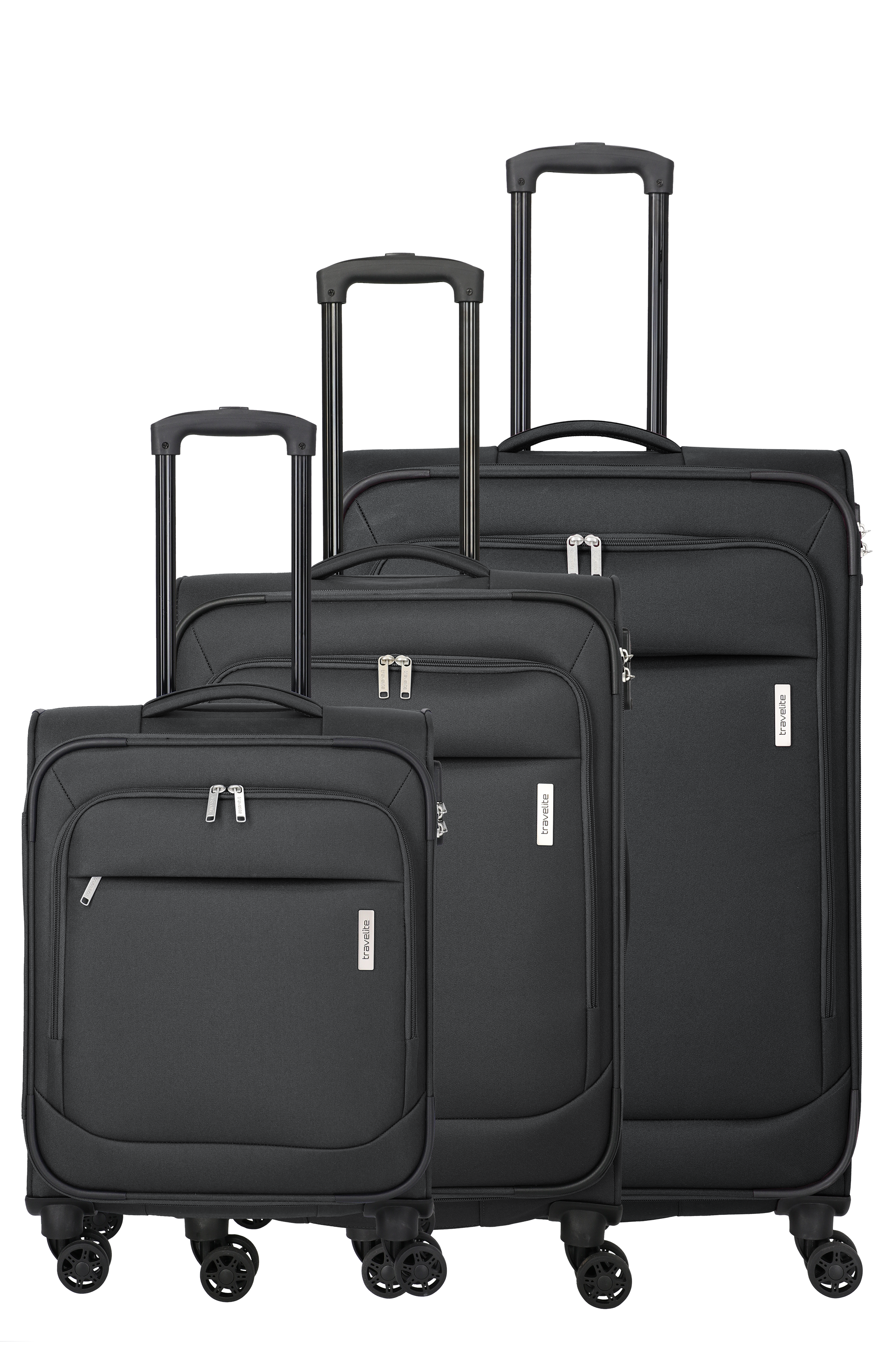 Three black trolley suitcases of the brand "travelite" in different sizes stand in front of a black background. Each has an extendable telescopic handle, four wheels and a discreet, rectangular brand label.