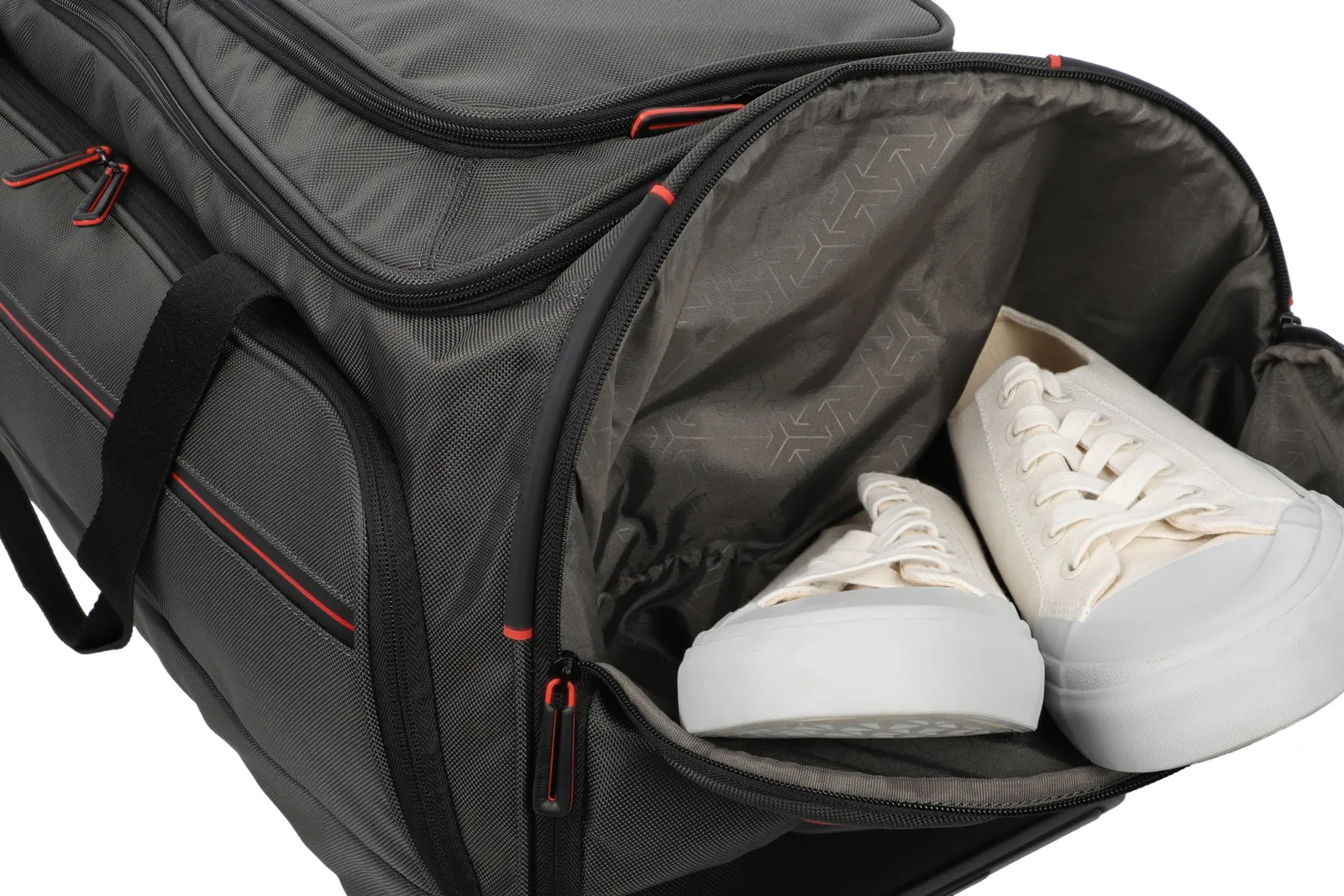 Sporttasche mit separatem Schuhfach und weißen Sneakern Detailaufnahme einer grauen Sporttasche mit separatem Schuhfach, in dem weiße Sneaker liegen